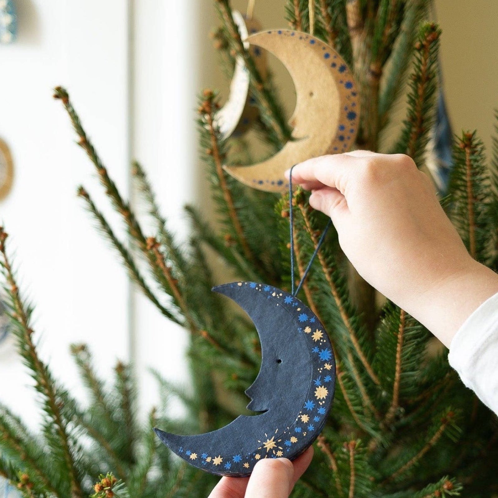 This fabulous gold and blue moon-shaped decoration has a matching 10cm cotton loop for hanging.