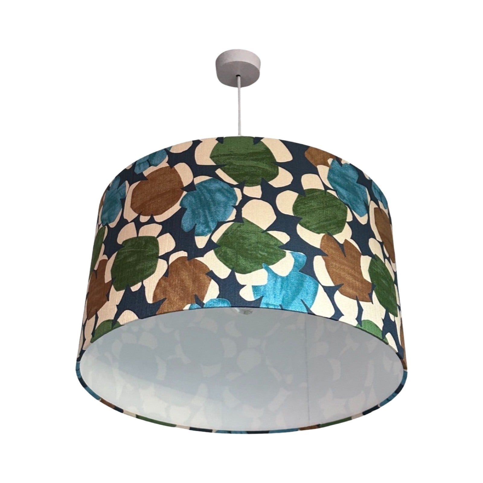 Drum lampshade covered in navy light barkcloth fabric with turquoise, green and brown flowers