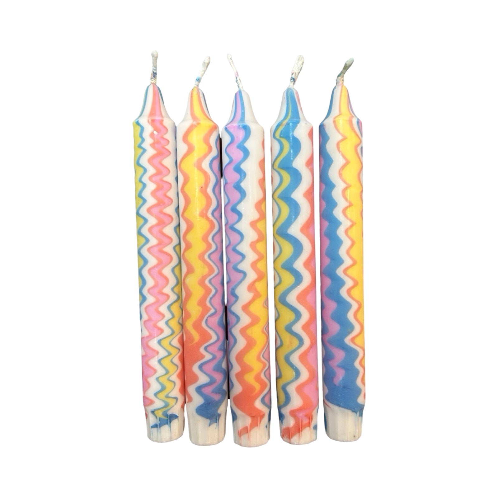 A row of five handmade dinner candle marbled in a blue, pink, yellow and orange in a zig zag pattern on a white background.