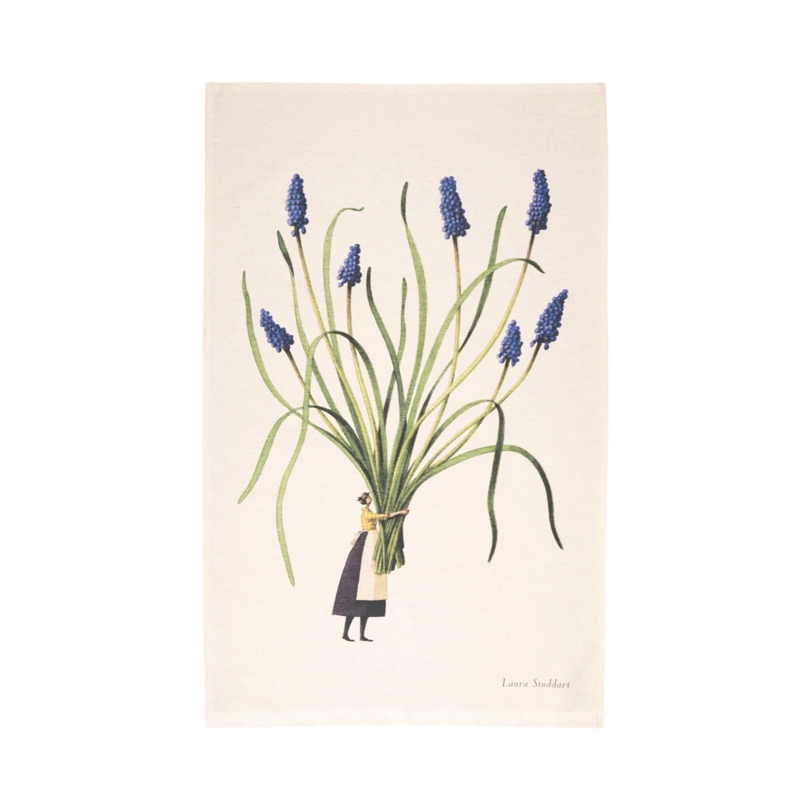 A tea towel featuring an illustration of a lady dressed in a yellow shirt, white apron and black skirt holding a giant bunch of purple muscari flowers.