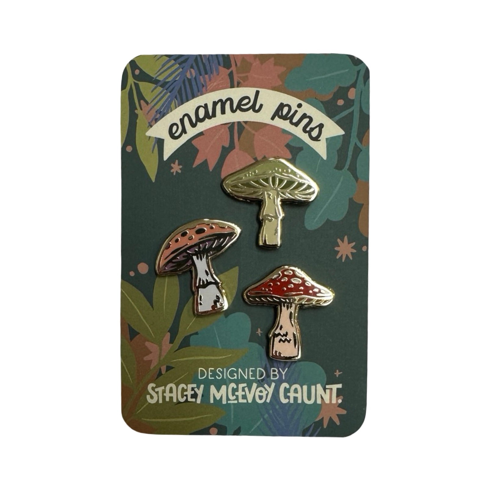 Three mushroom-shaped enamel pins on a decorative card with 'Stacey Meevoy Caunt' branding.