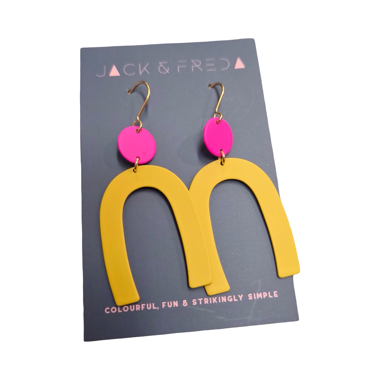 Pair of earrings with pink circular tops and yellow arch-shaped bottoms on blue backing card.