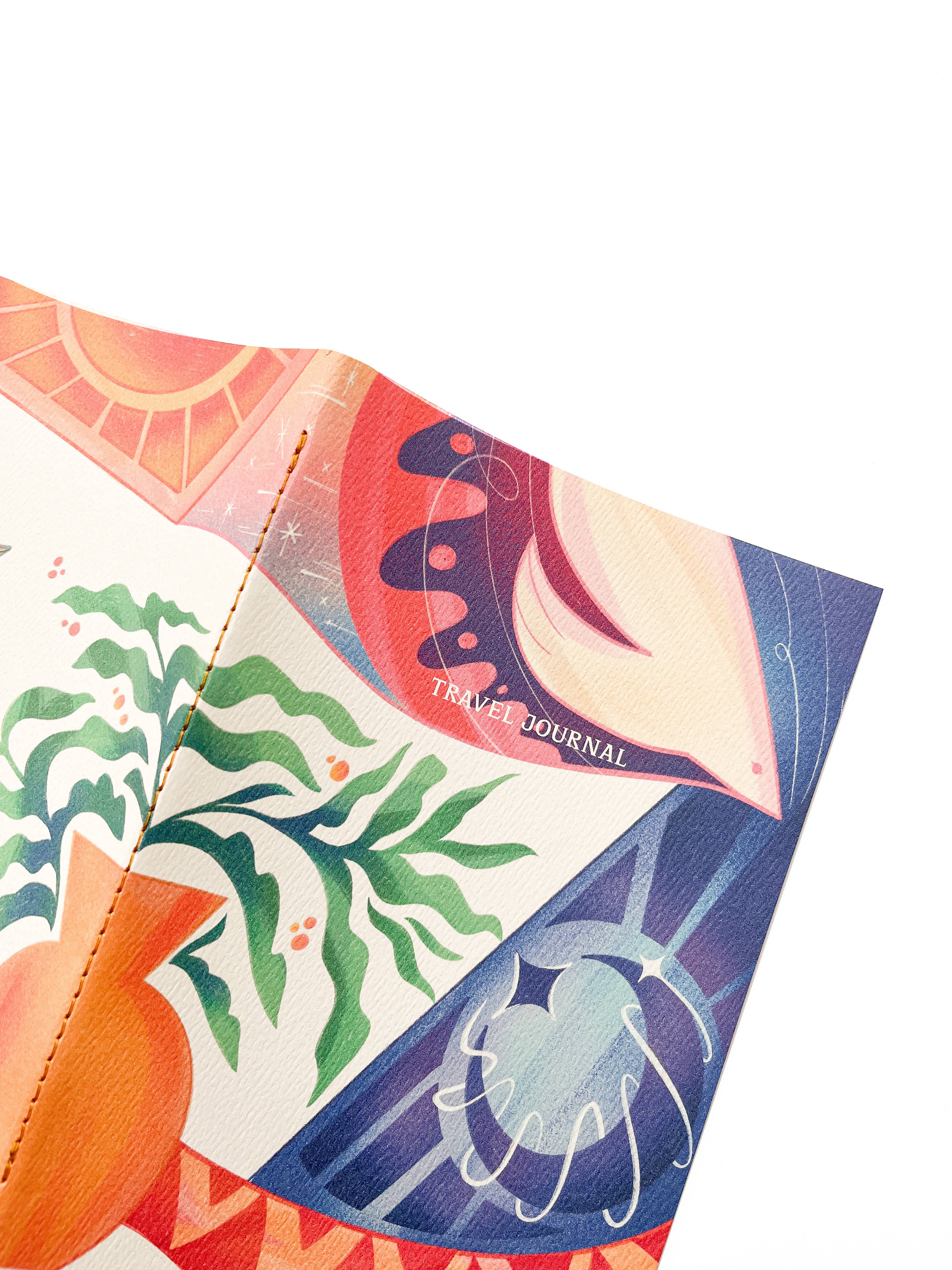 Colorful travel journal with abstract designs on a white background.