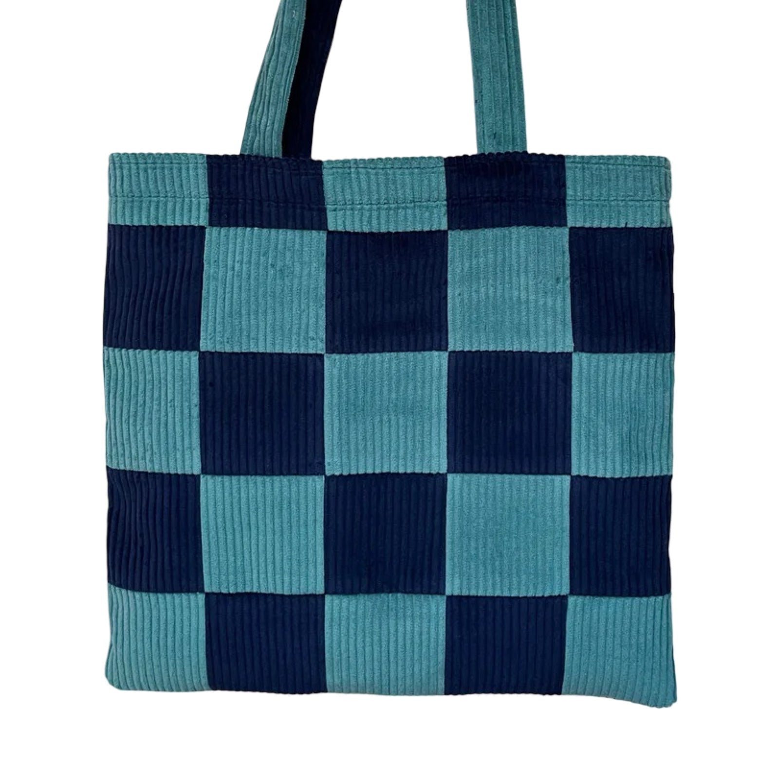 Checkered tote bag with blue and navy pattern on a white background.