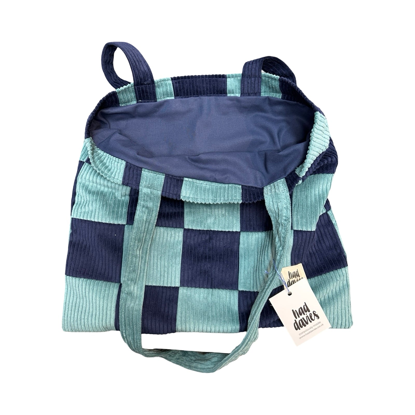 Checkered bag with a tag on a white background.