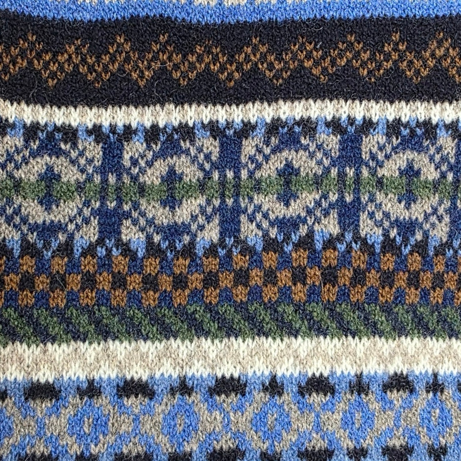 Close-up of a patterned fabric with blue, black, and white colors.