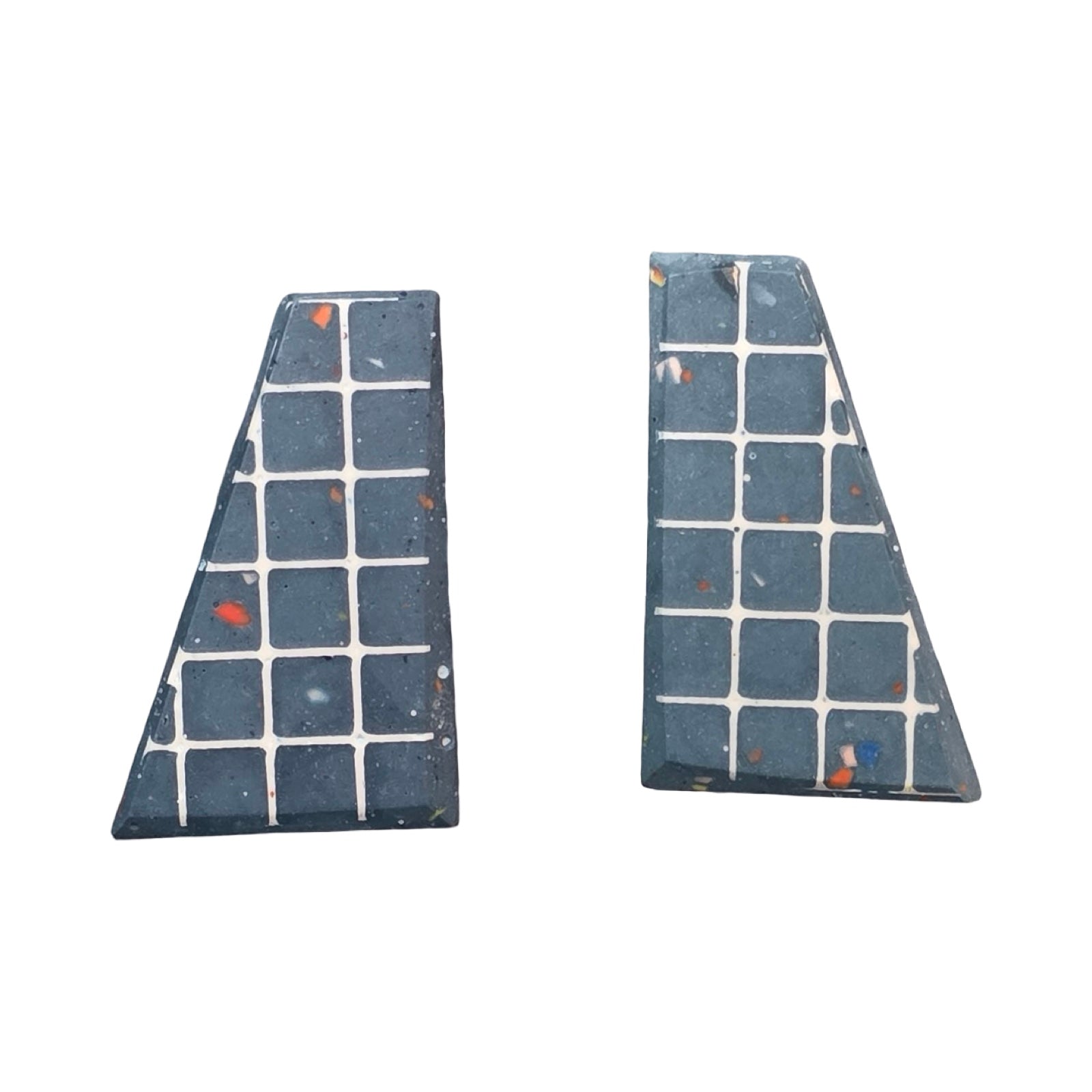 Navy trapezoid-shaped stud earrings with a white grid pattern.