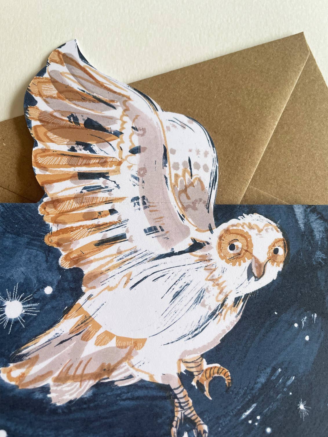 Card with a painted owl design on a starry night background.