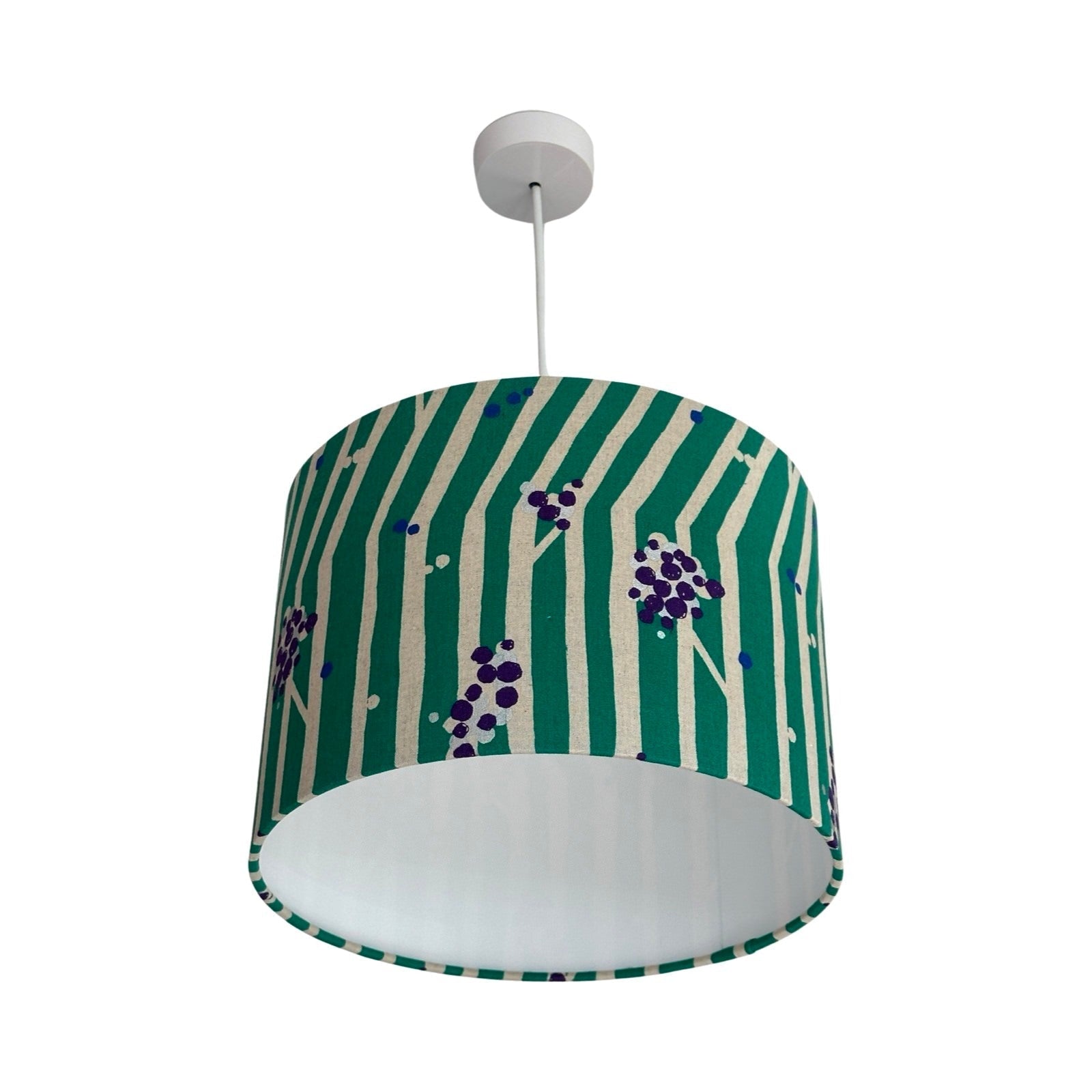 Drum lampshade featuring purple and silver clusters of nuts and white tree branches against a green background
