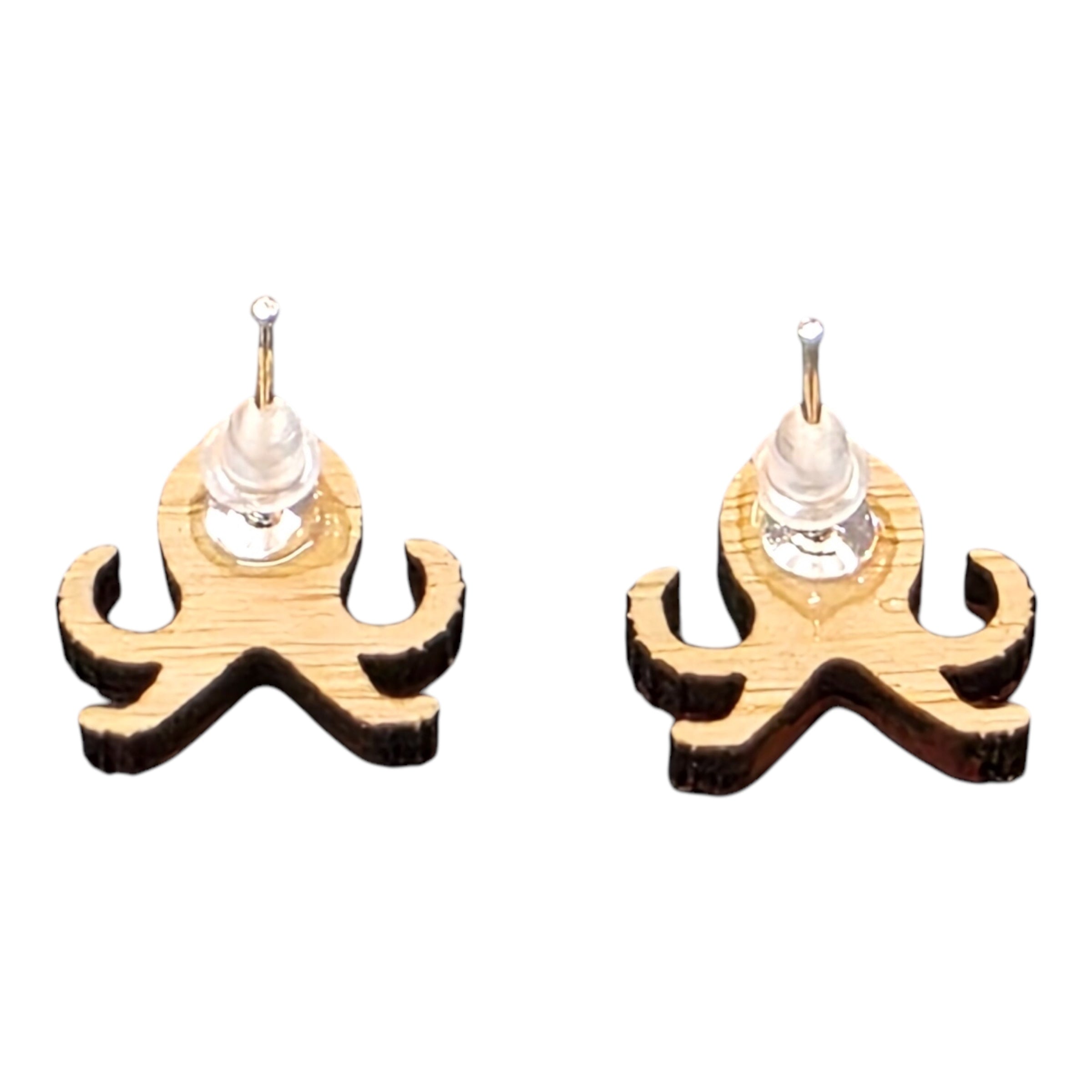 The back of a pair of wooden octopus-shaped earrings with silver coloured posts and rubber backs.