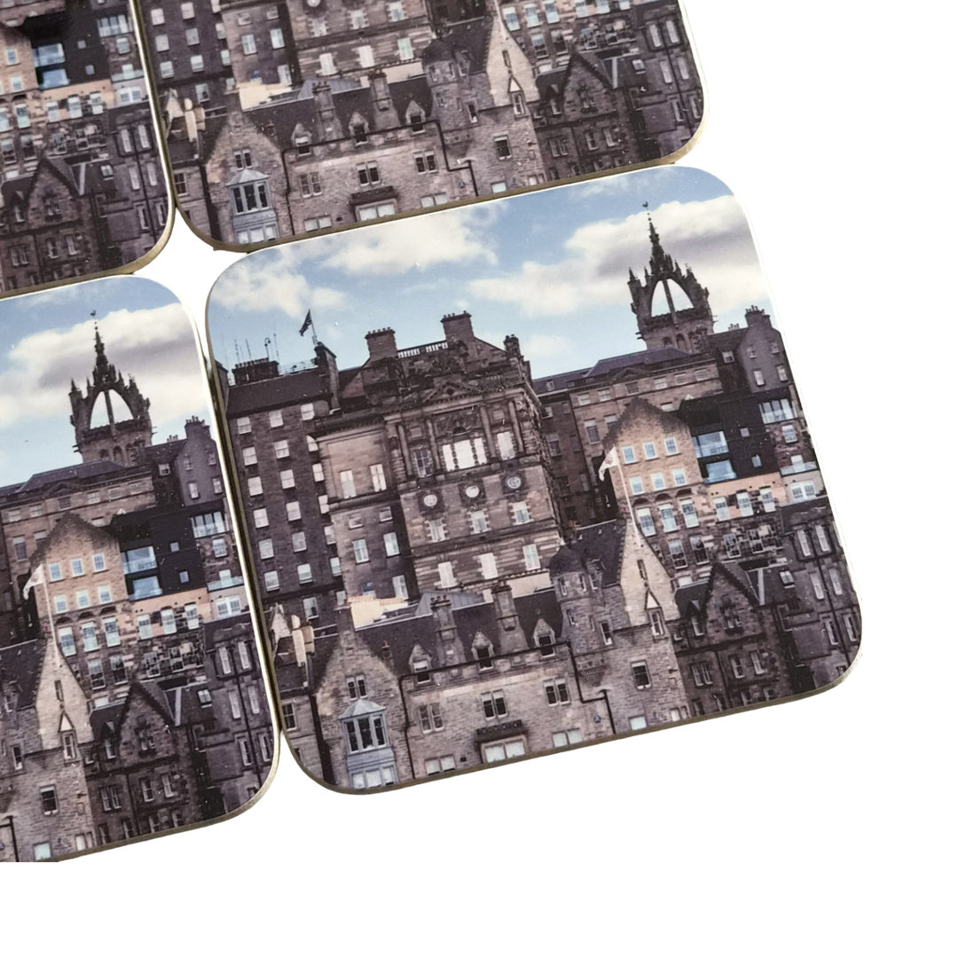 Set of four coasters with architectural design on a white background