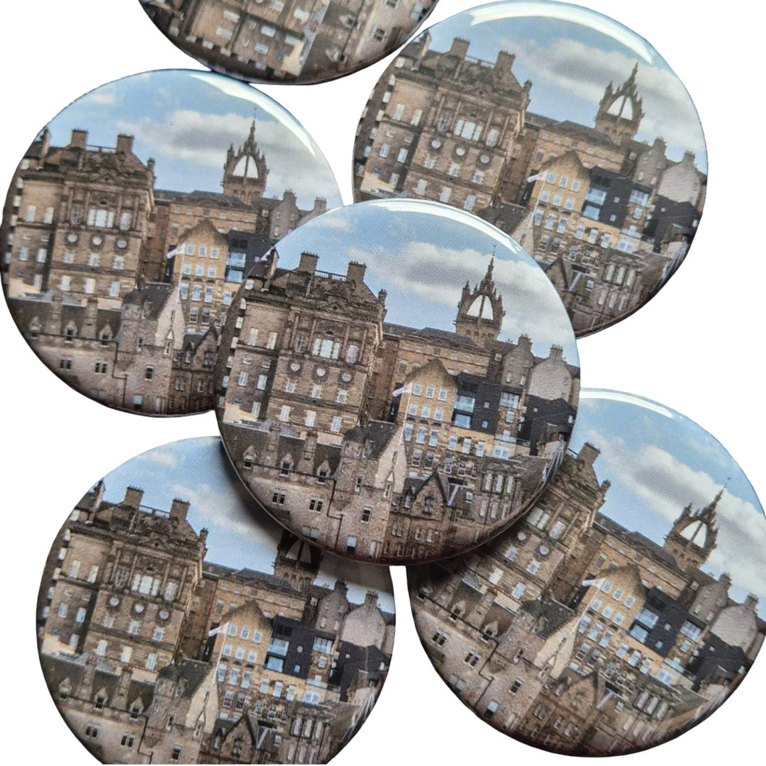 Set of circular magnets with cityscape design on a white background