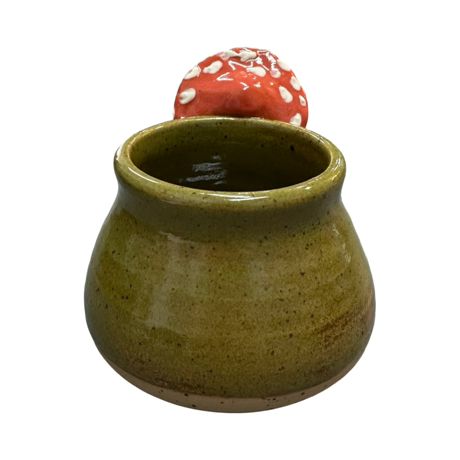 Green ceramic mug with a red and white mushroom handle on a white background.