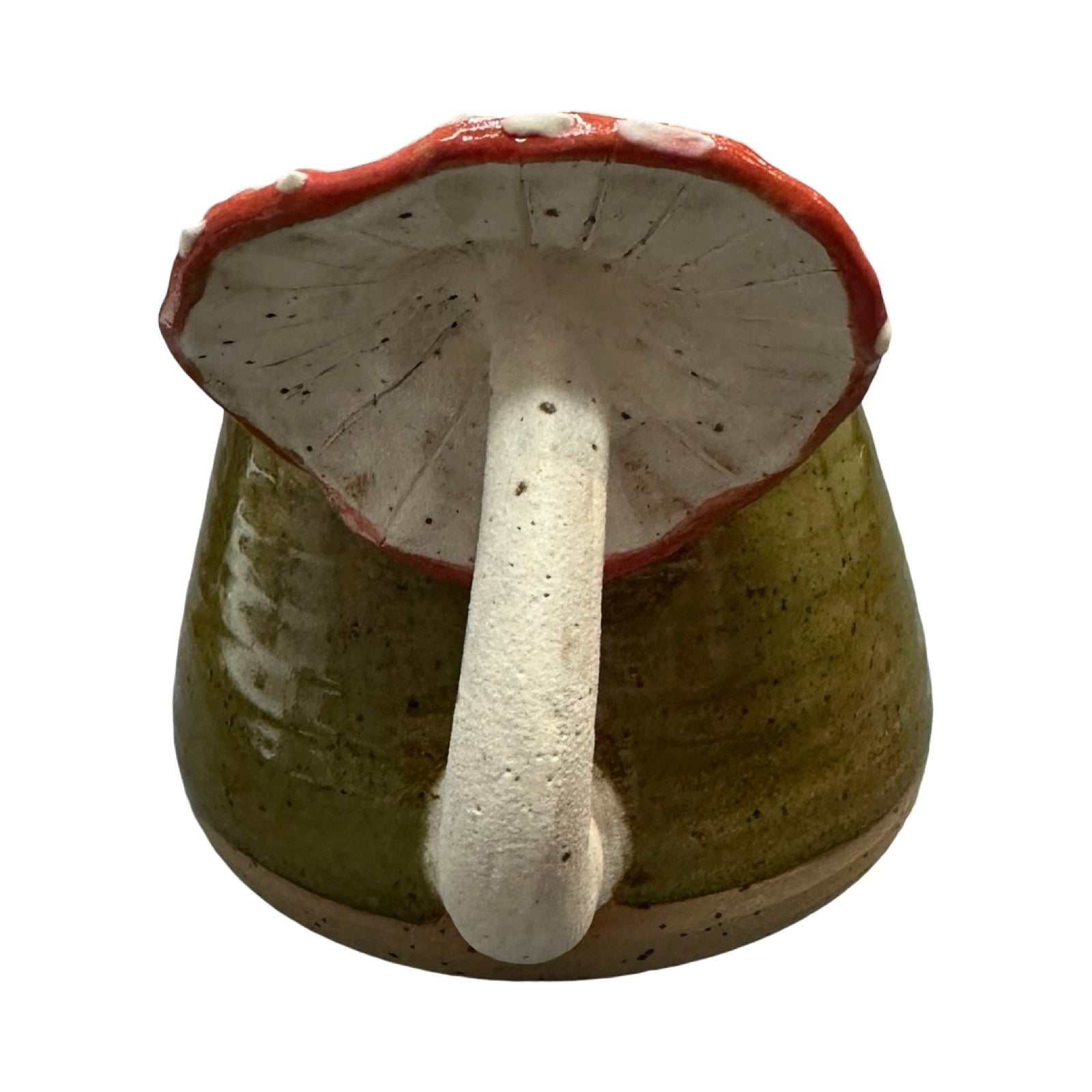 Ceramic mushroom-shaped mug with a red handle on a white background.