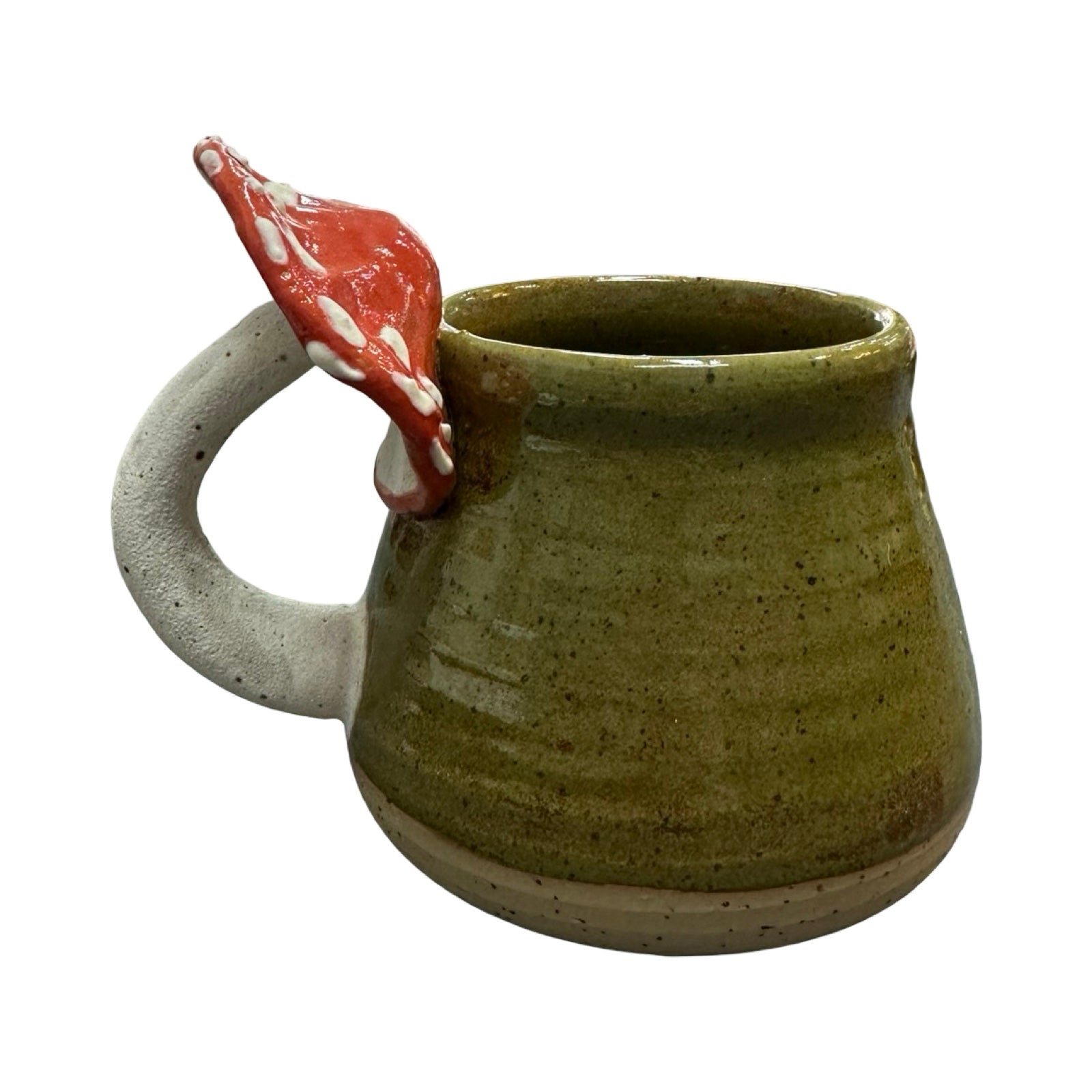 Green ceramic mug with a red and white mushroom handle on a white background.