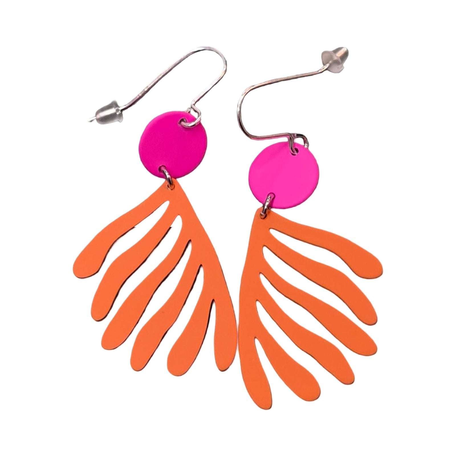 Pair of earrings with pink circular top and orange leaf-like bottom on a white background.