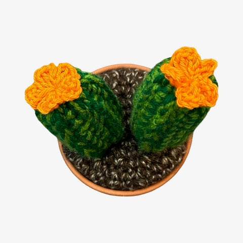 Handmade 2 pronged crochet cactus with orange flowers.