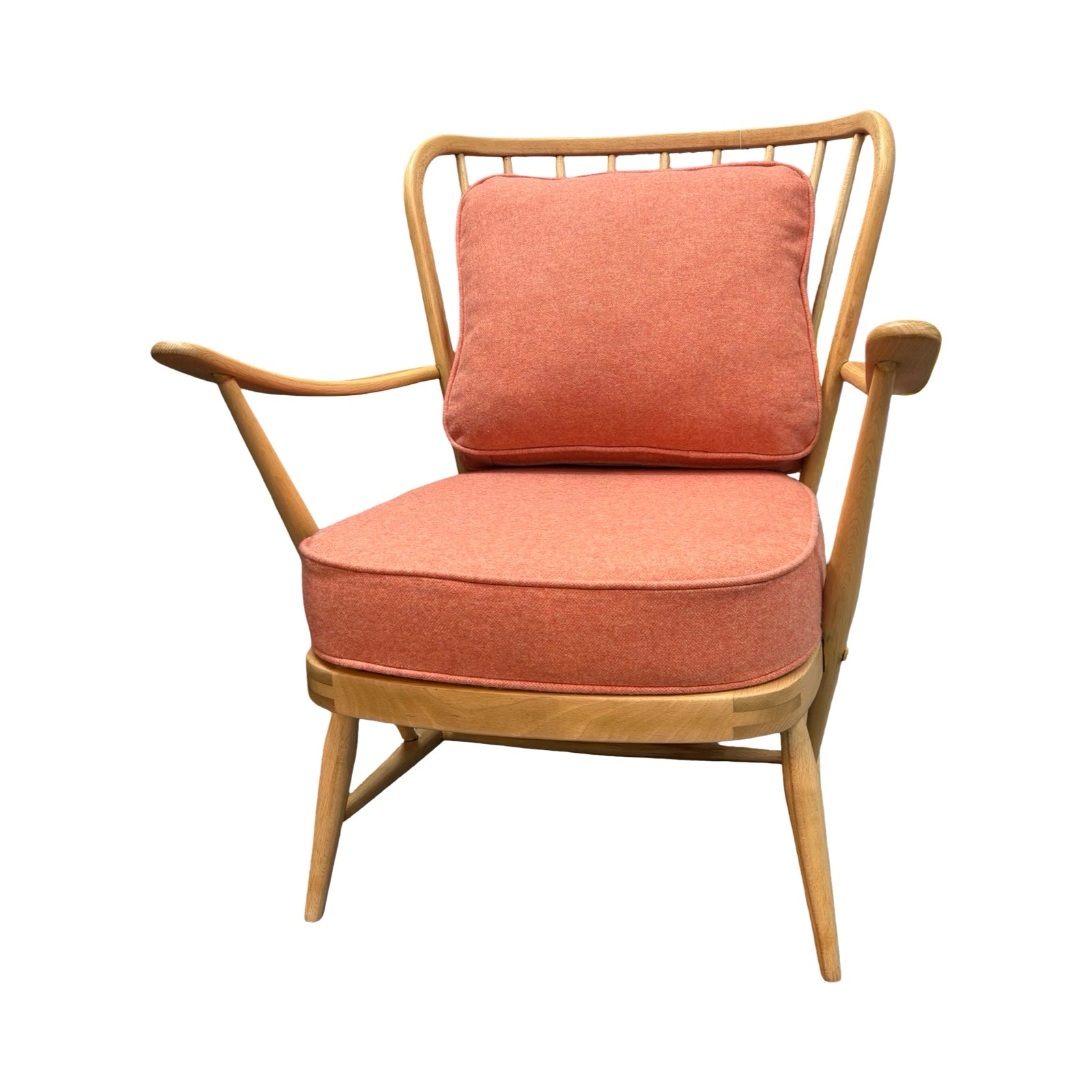 Chair with orange cushions and wooden frame on a white background.
