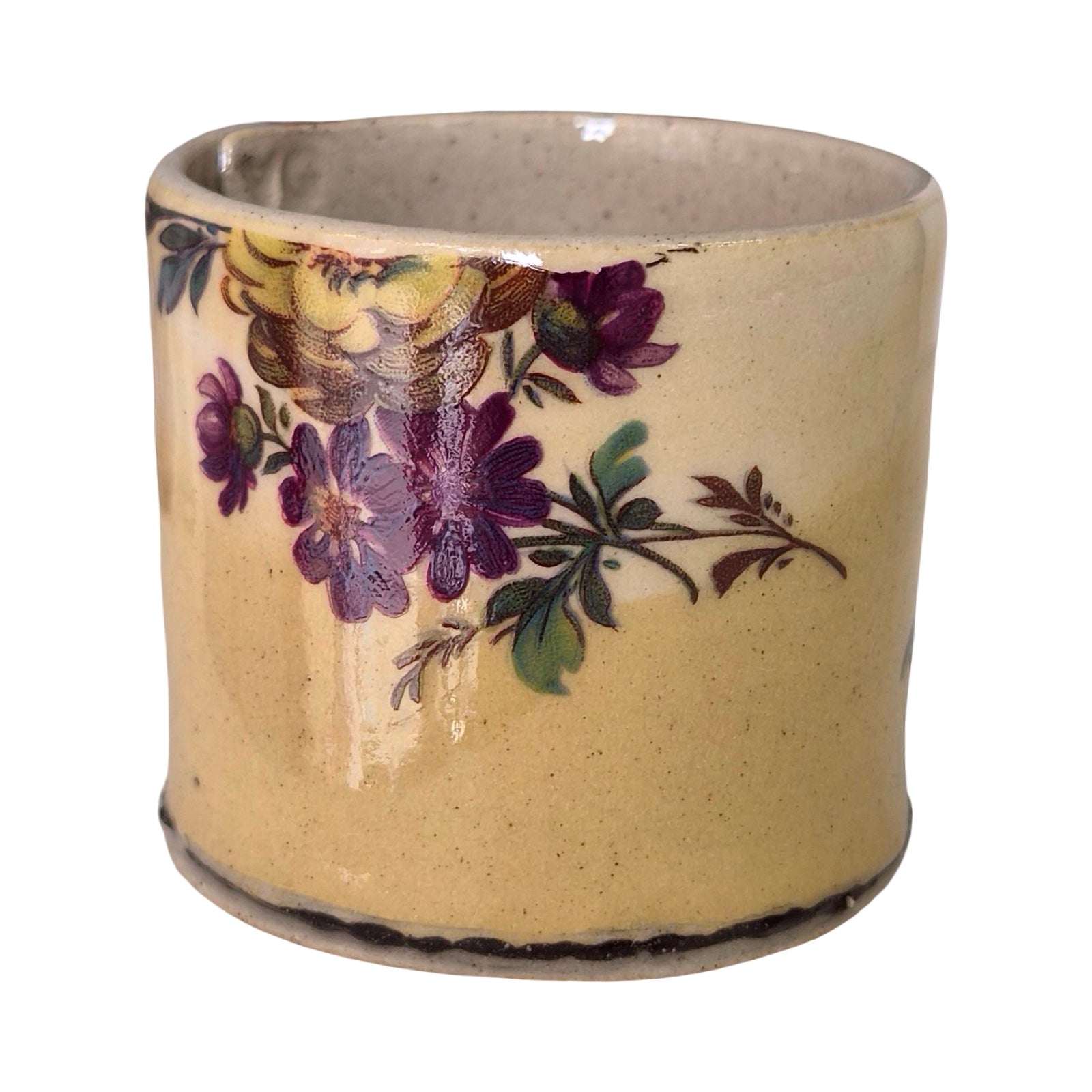 Ceramic planter with floral design on a beige background.
