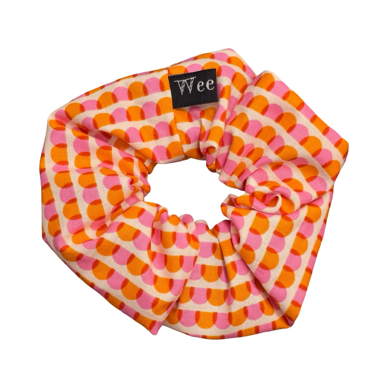 This handmade hair scrunchie is made from 100% cotton fabric with an orange and pink scalloped pattern.
