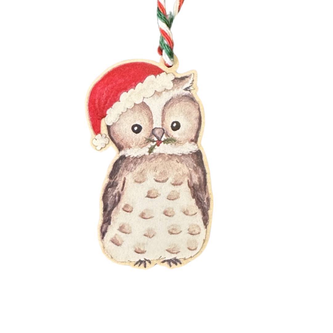 Wooden Christmas decoration of an owl wearing a Santa hat.