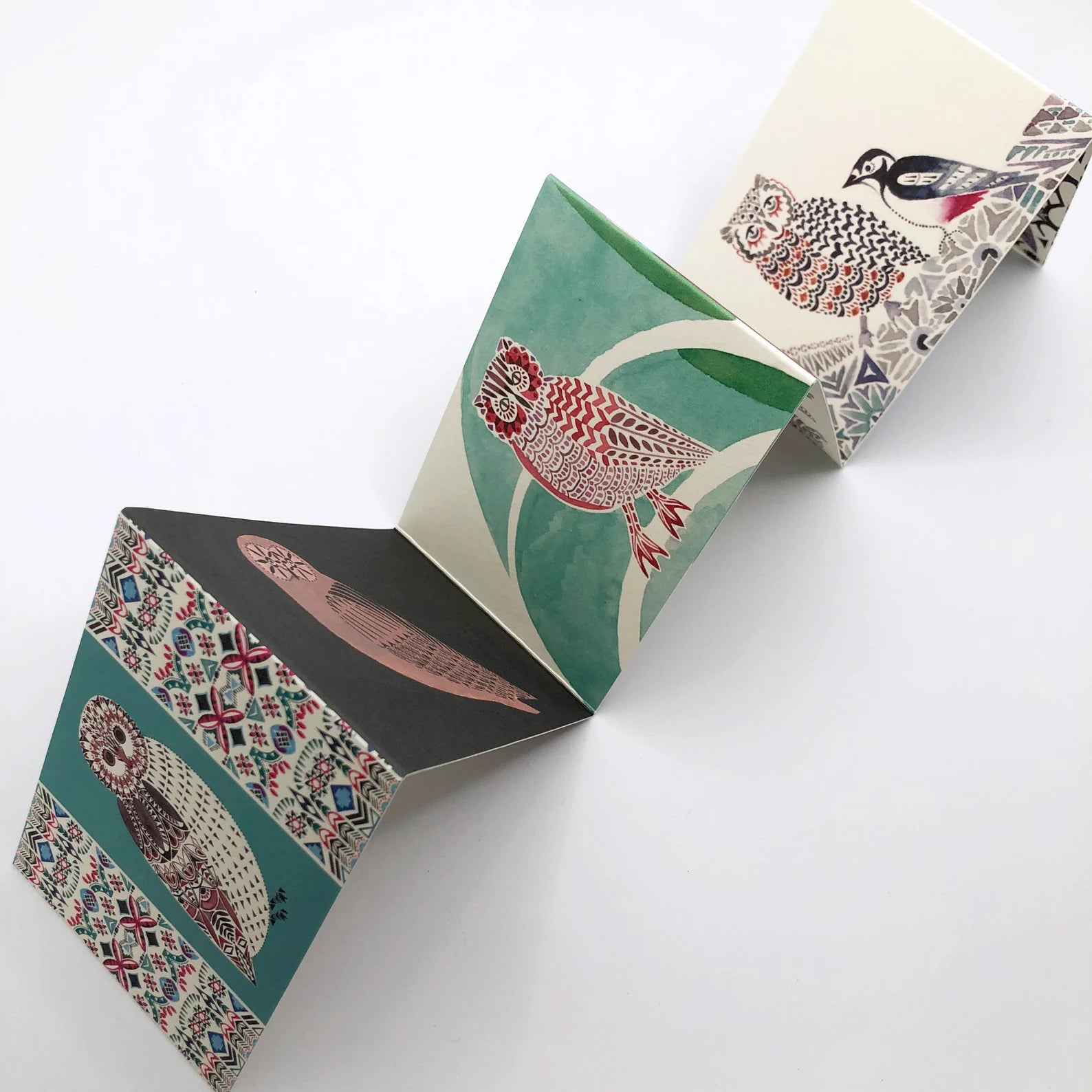 Open card with bird illustrations on a white background.