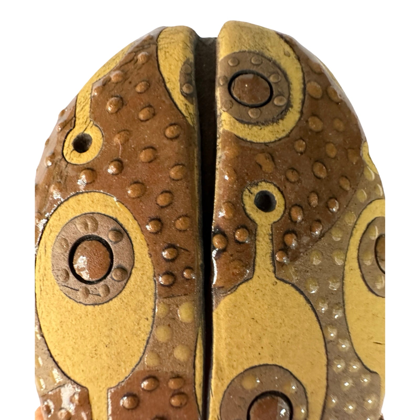 Ceramic beetle decorated in brown with a yellow paddle-shaped pattern.