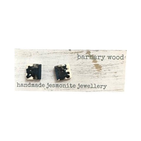 Square stud earrings in a blue, grey, black and white paint design with silver ear posts.