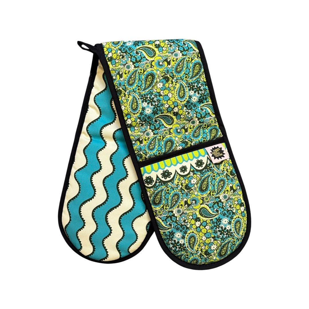 Green and blue paisley pattern design oven gloves with turquoise and cream wiggly stripes on the reverse.