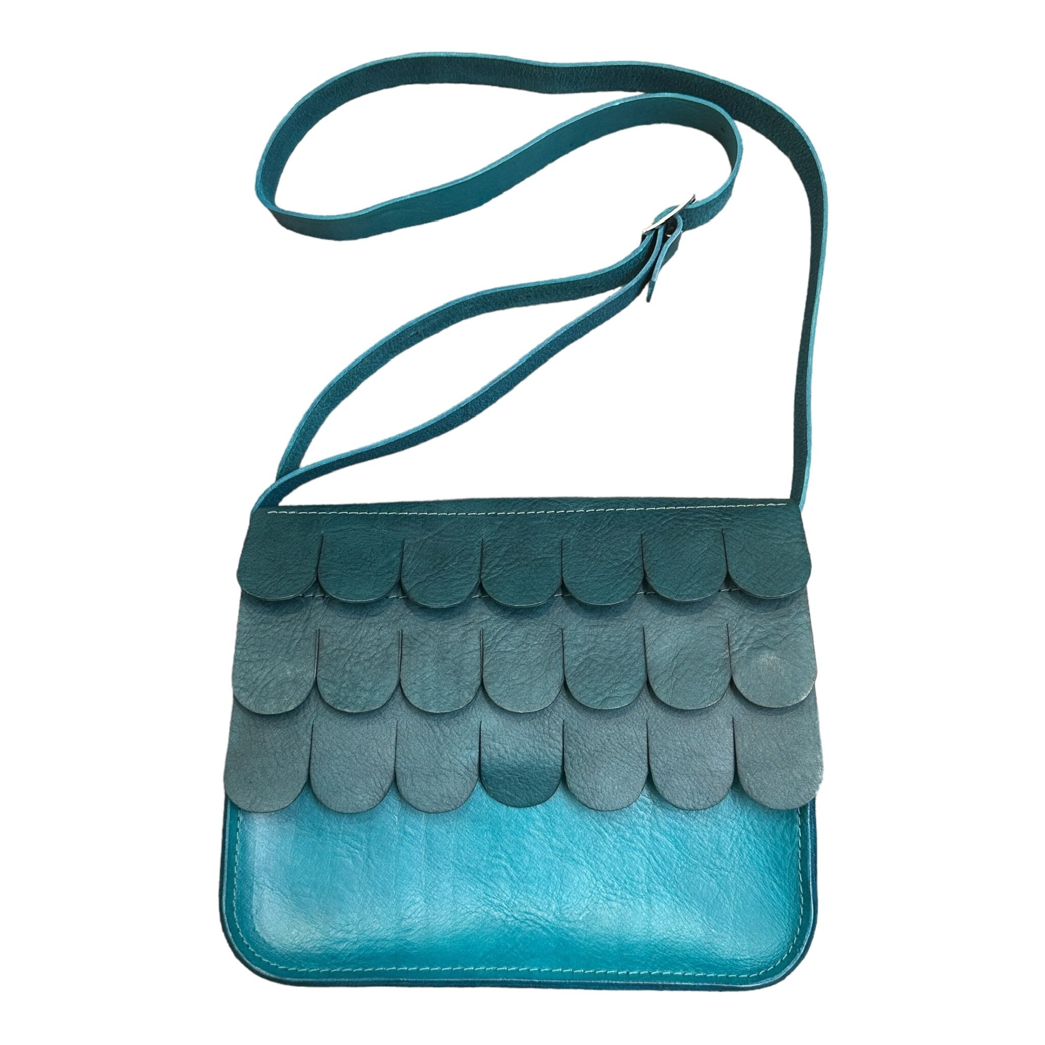 Leather satchel made from hand dyed vegetable tanned leather, with contrasting textured wave flap which closes with a hidden magnetic clasp and has an adjustable strap.