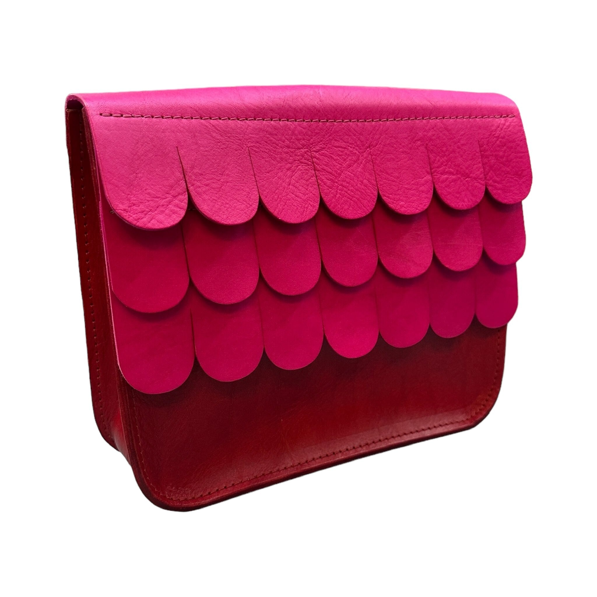 Leather satchels are made from hand dyed vegetable tanned leather, with contrasting textured wave flap which closes with a hidden magnetic clasp and has an adjustable strap.