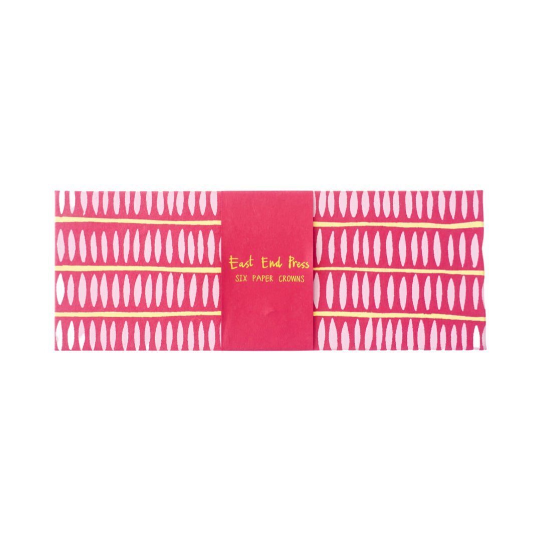 A pink cardboard box with light pink ovals for party paper crowns in pink.