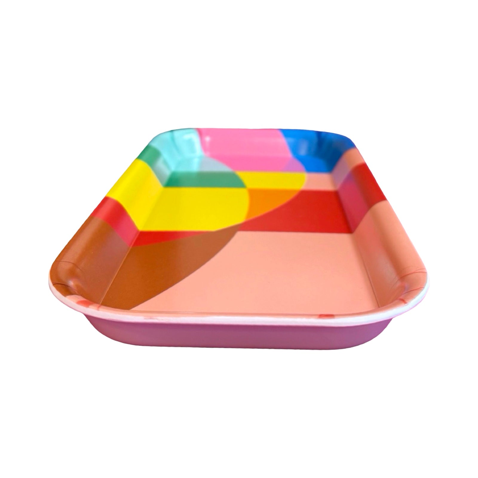 The side of a multicoloured geometric rectangular tray with main colours of coral, red and yellow.