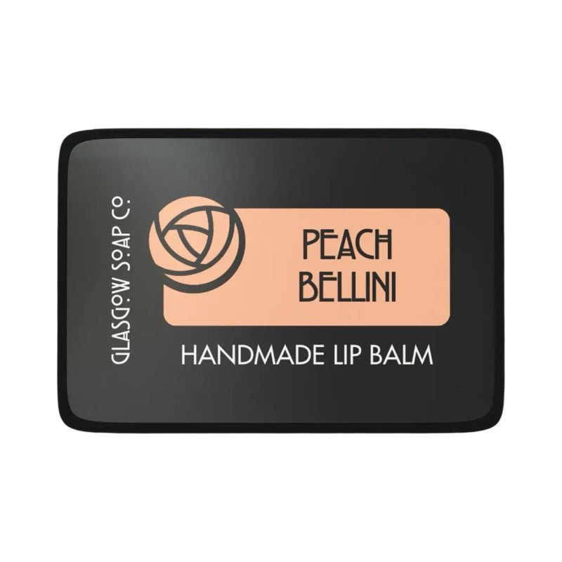 A small black tin of peach bellini lip balm