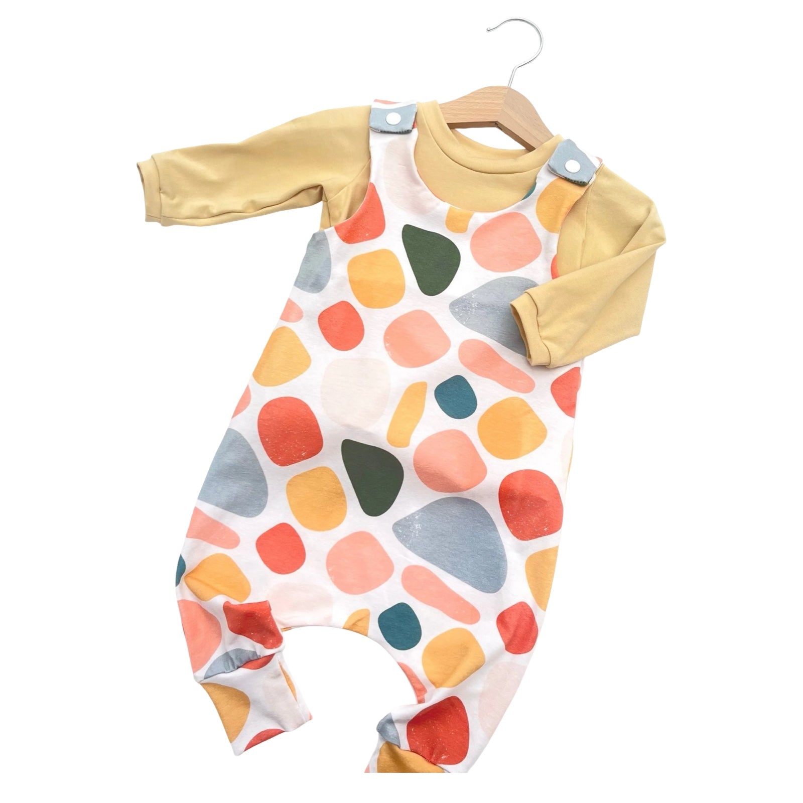 Colorful baby romper with geometric pattern on a white background.