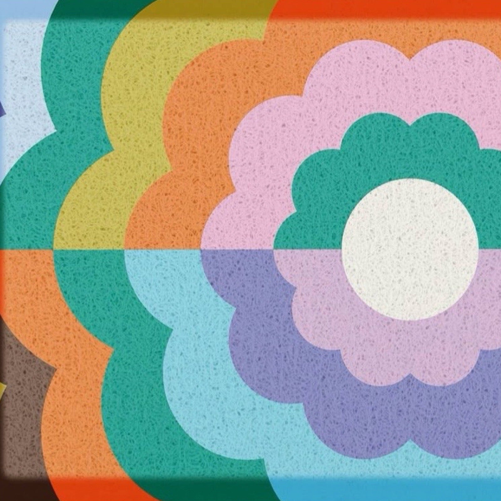 A doormat featuring a retro 1970s-style floral pattern with concentric scalloped flower shapes in pink, purple, teal, light blue, orange, yellow, and green on a speckled surface.