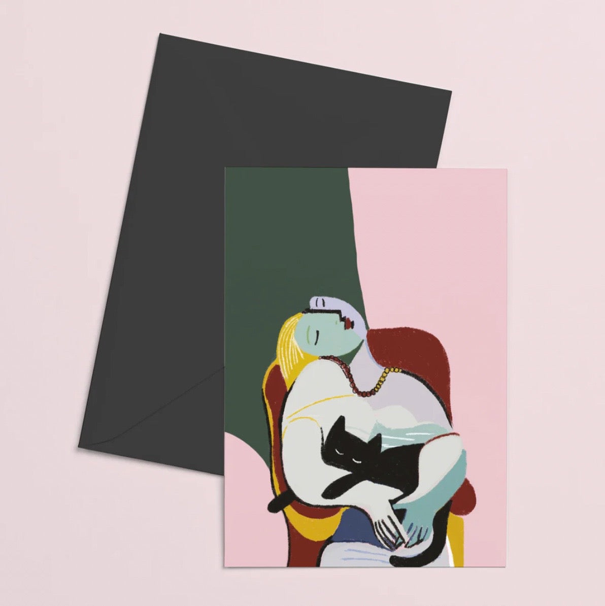 Greeting card with a woman holding a black cat and a matching envelope on a pink background.