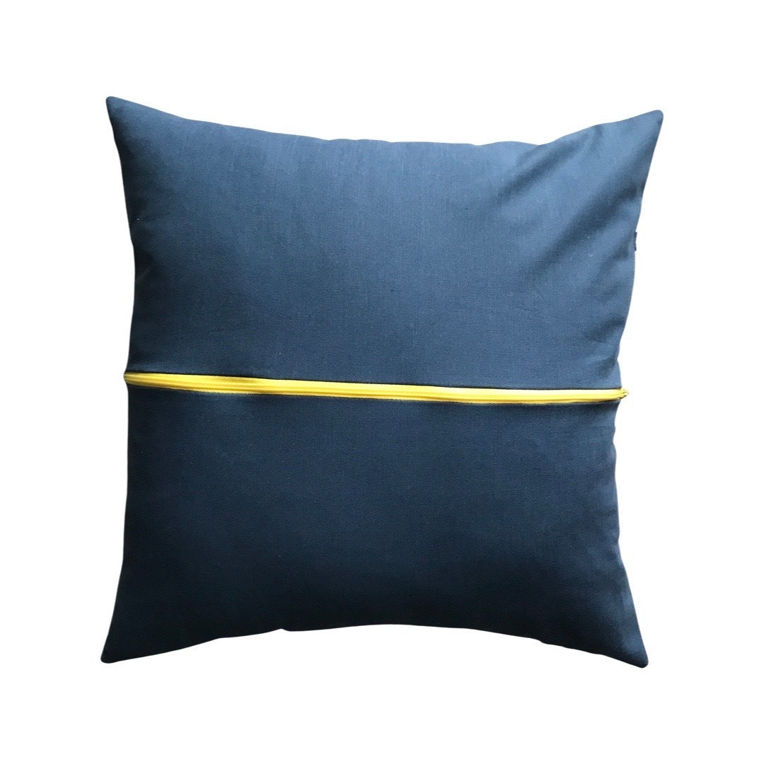 A blue cushion cover with a yellow zip.