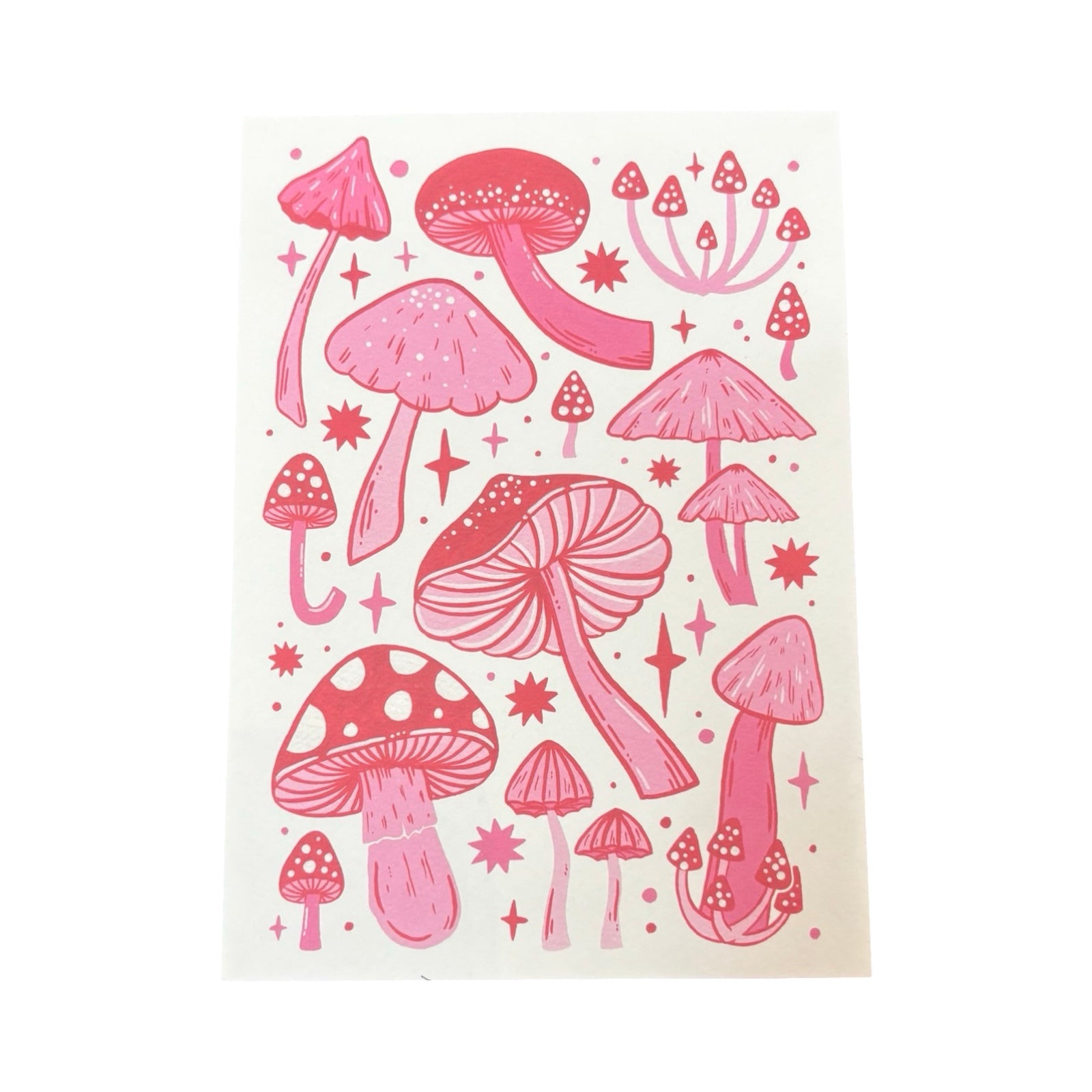 This postcard features variations of red toadstools.