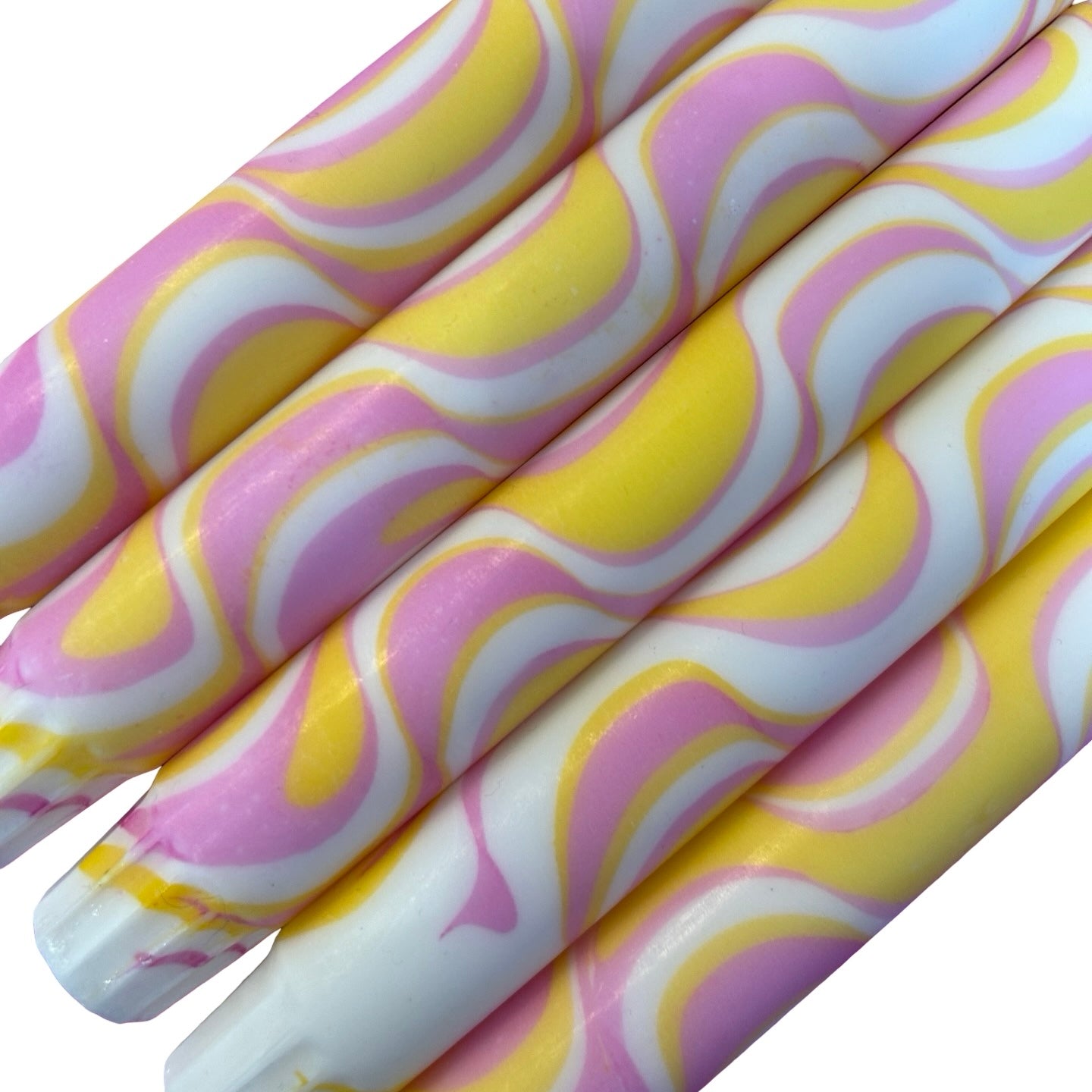 Close up of pink and yellow marbled dinner candlers.