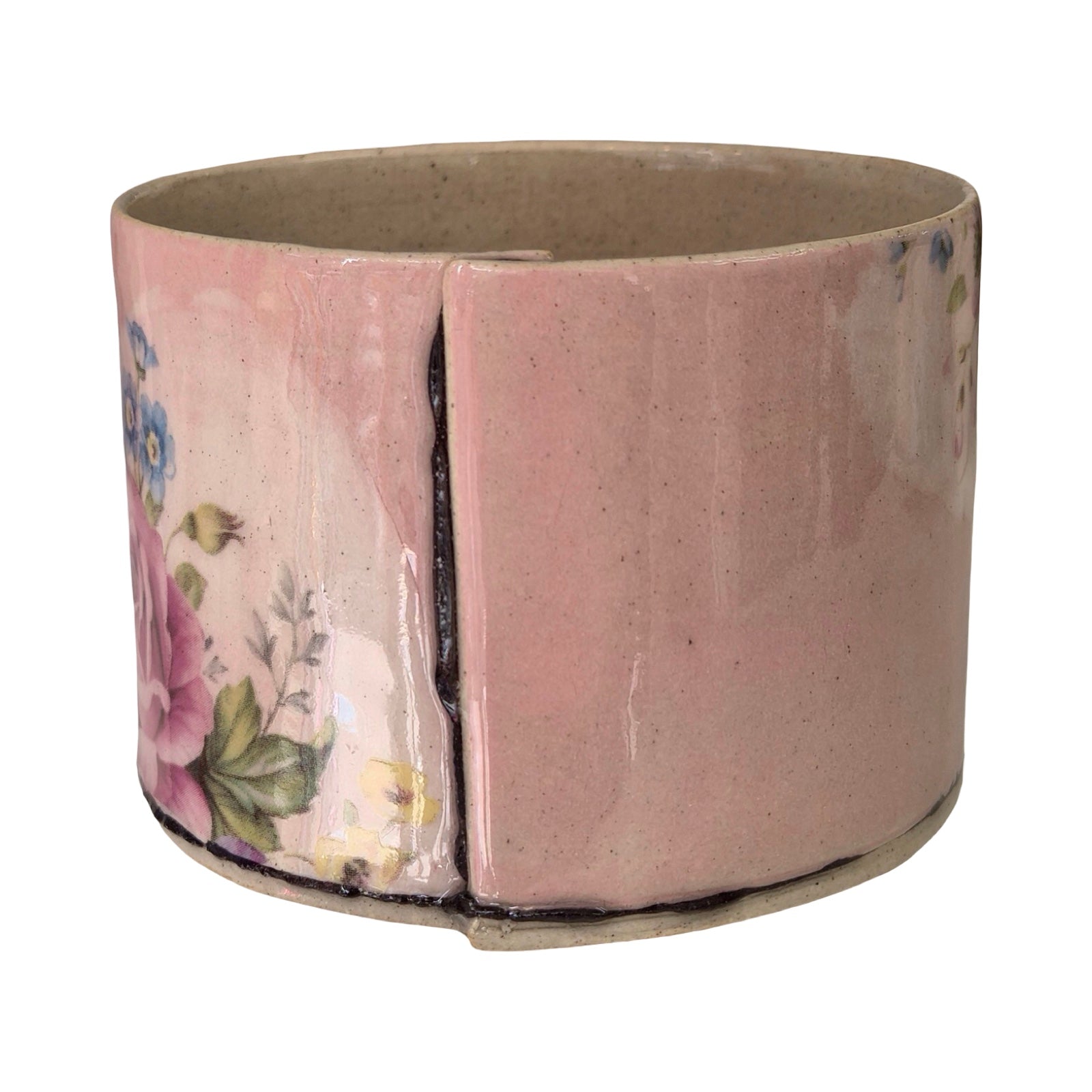 Ceramic planter with floral design on a white background.