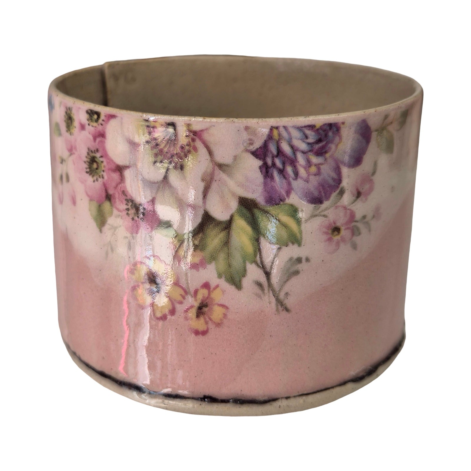 Ceramic planter with floral design on a white background.