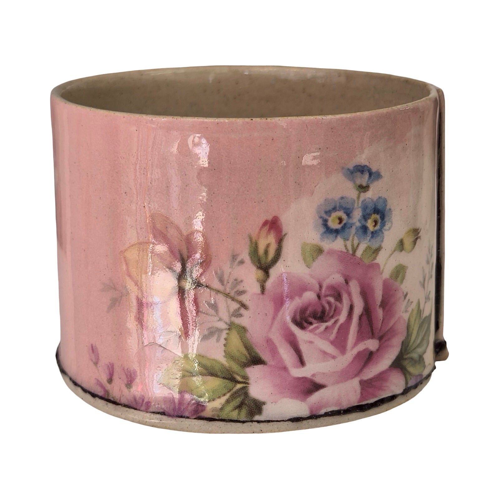 Ceramic planter with floral design on a white background.