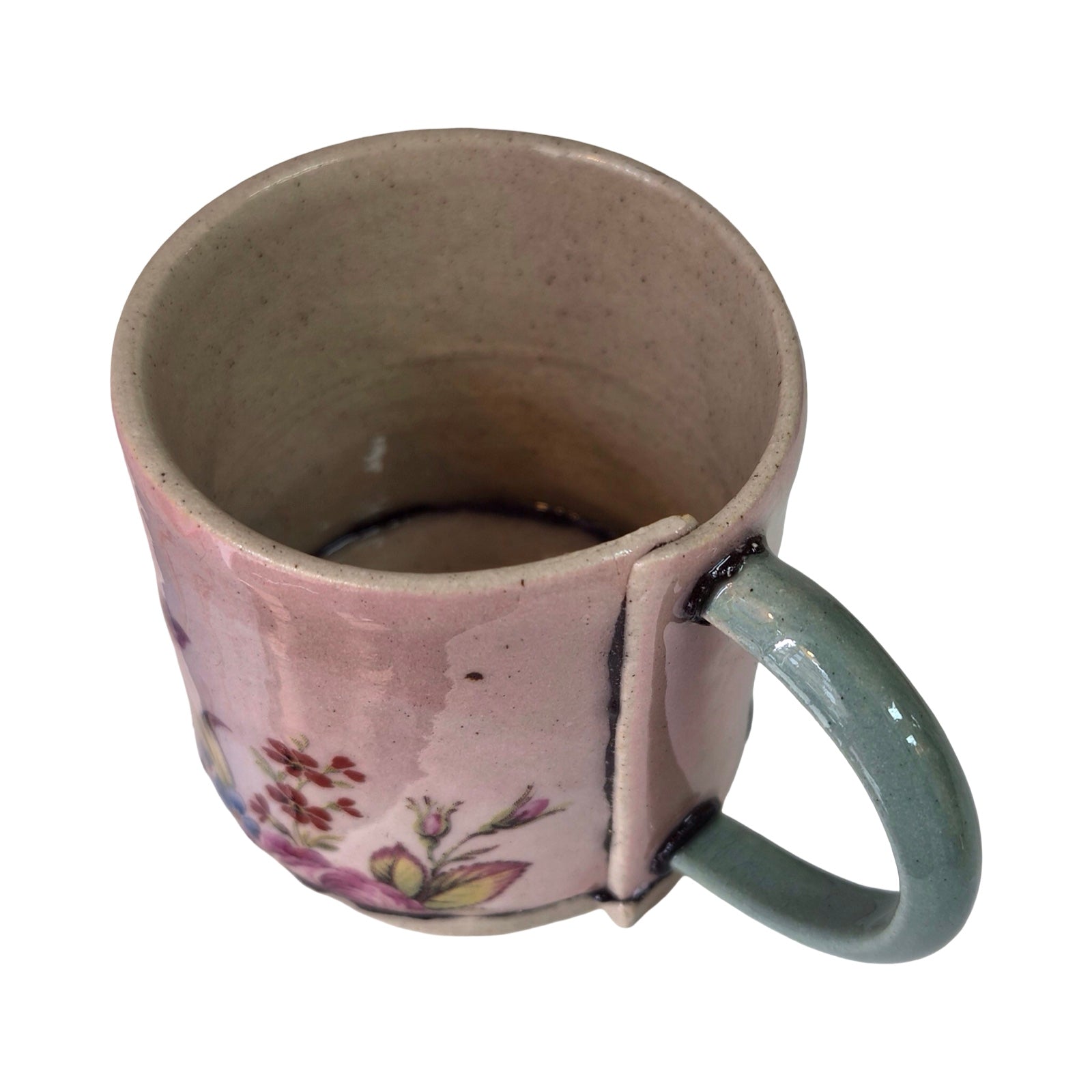 Ceramic mug with floral patterns on a white background.