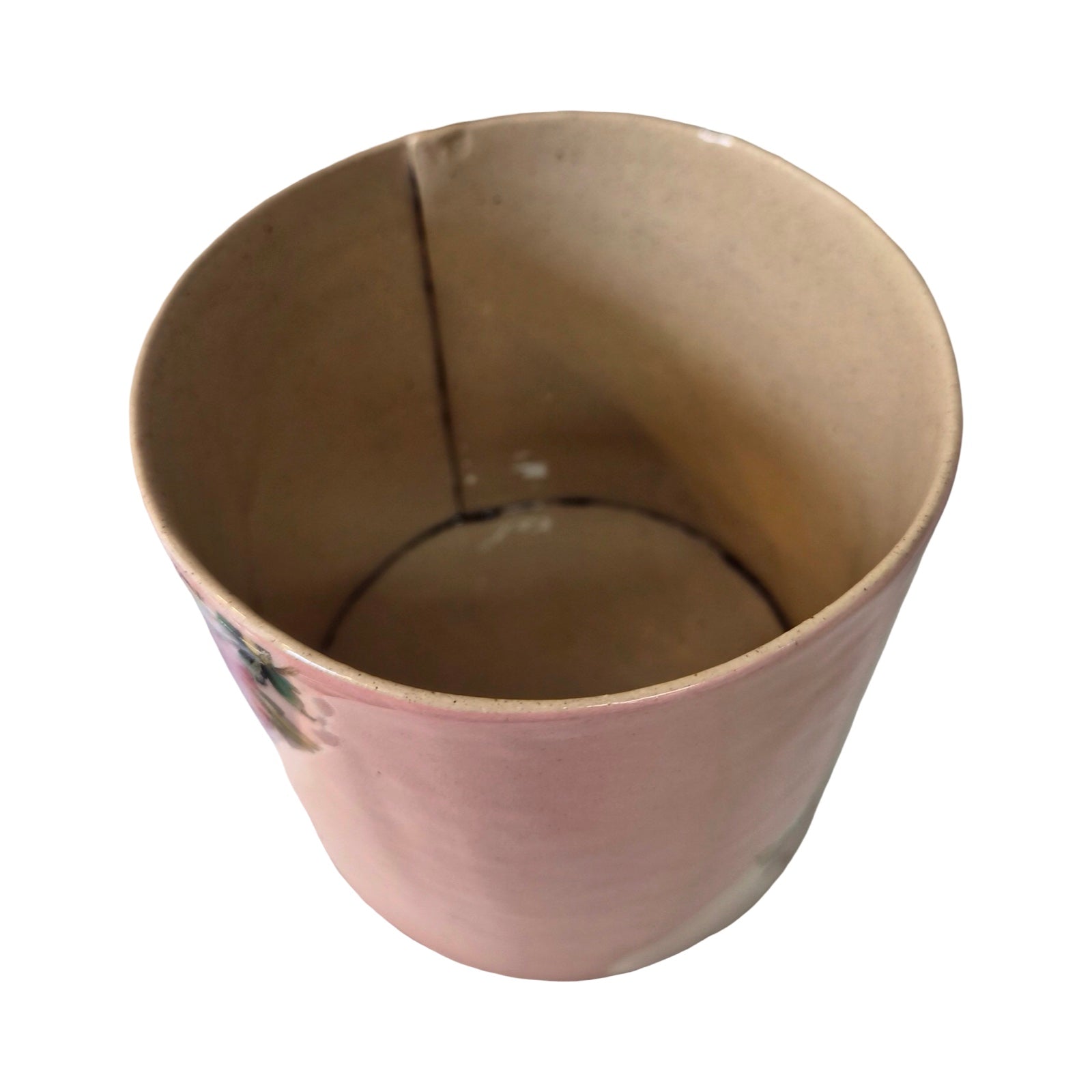 Inside of ceramic planter with a crack on a white background.