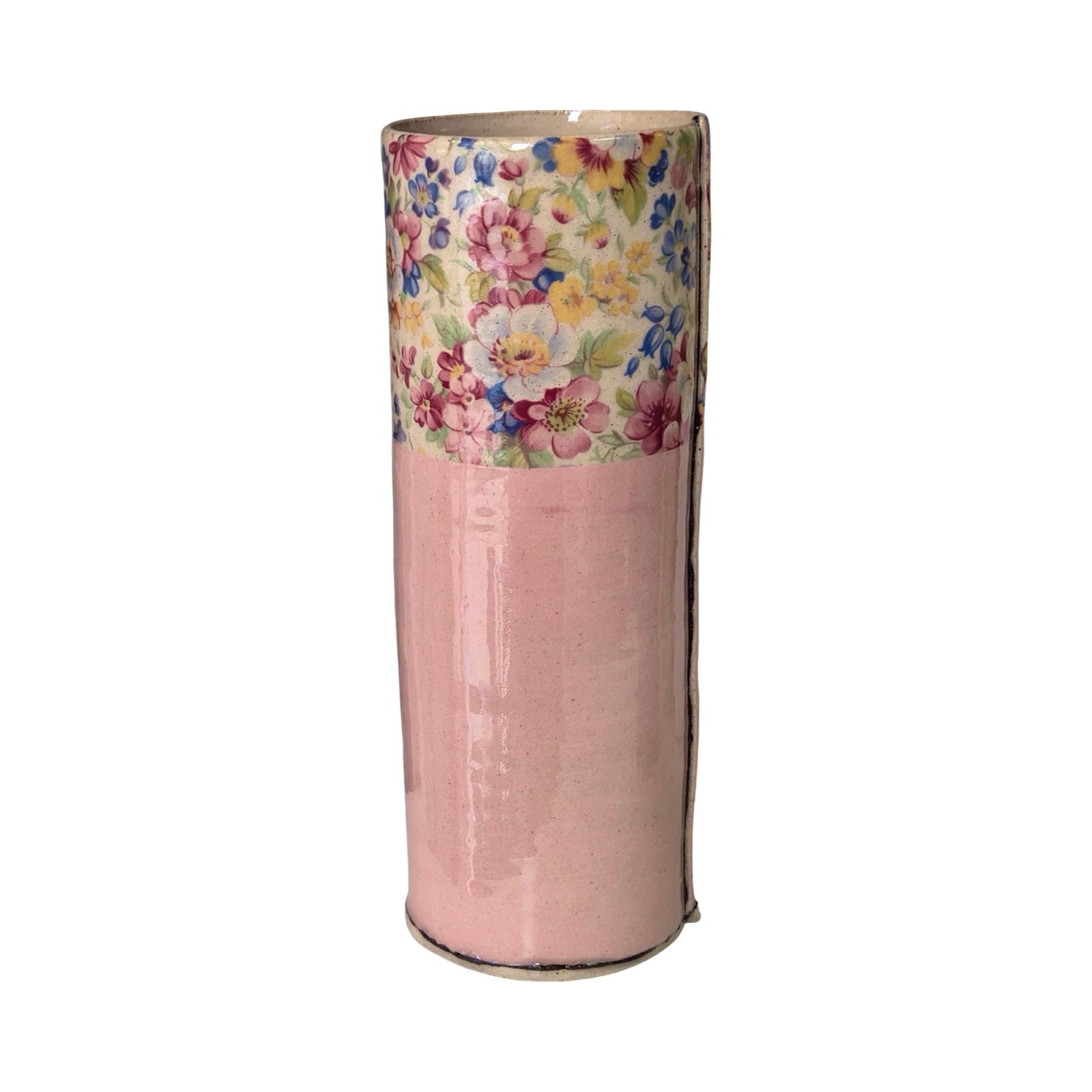 Cylindrical vase with floral top section and pink base on a white background.
