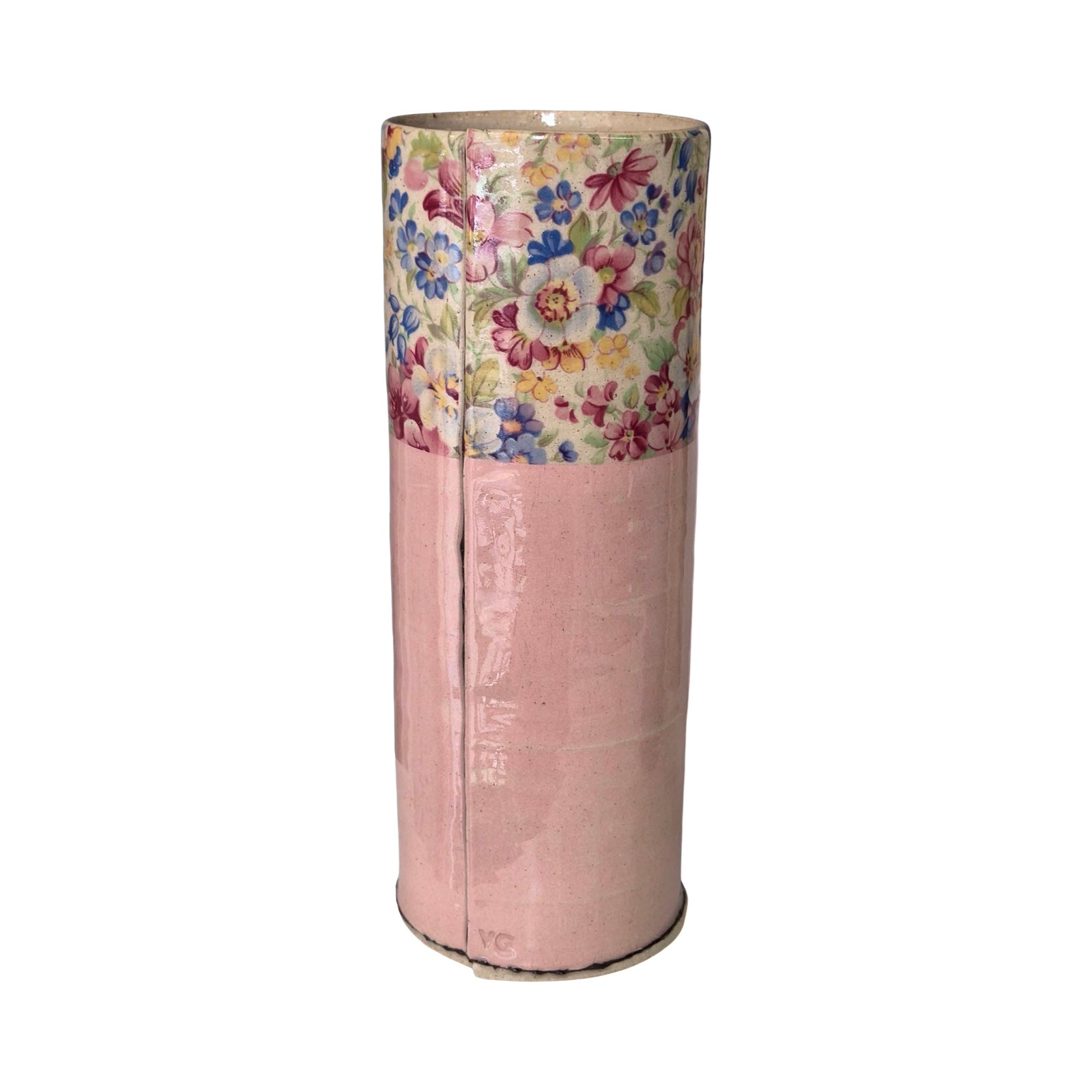 Cylindrical pink vase with floral top section on a white background.