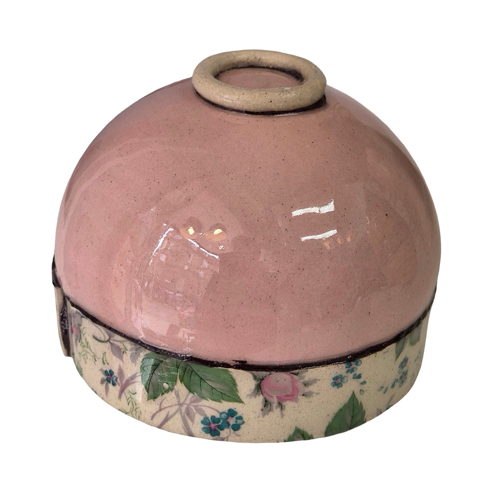 Upturned ceramic bowl with floral base on a white background.