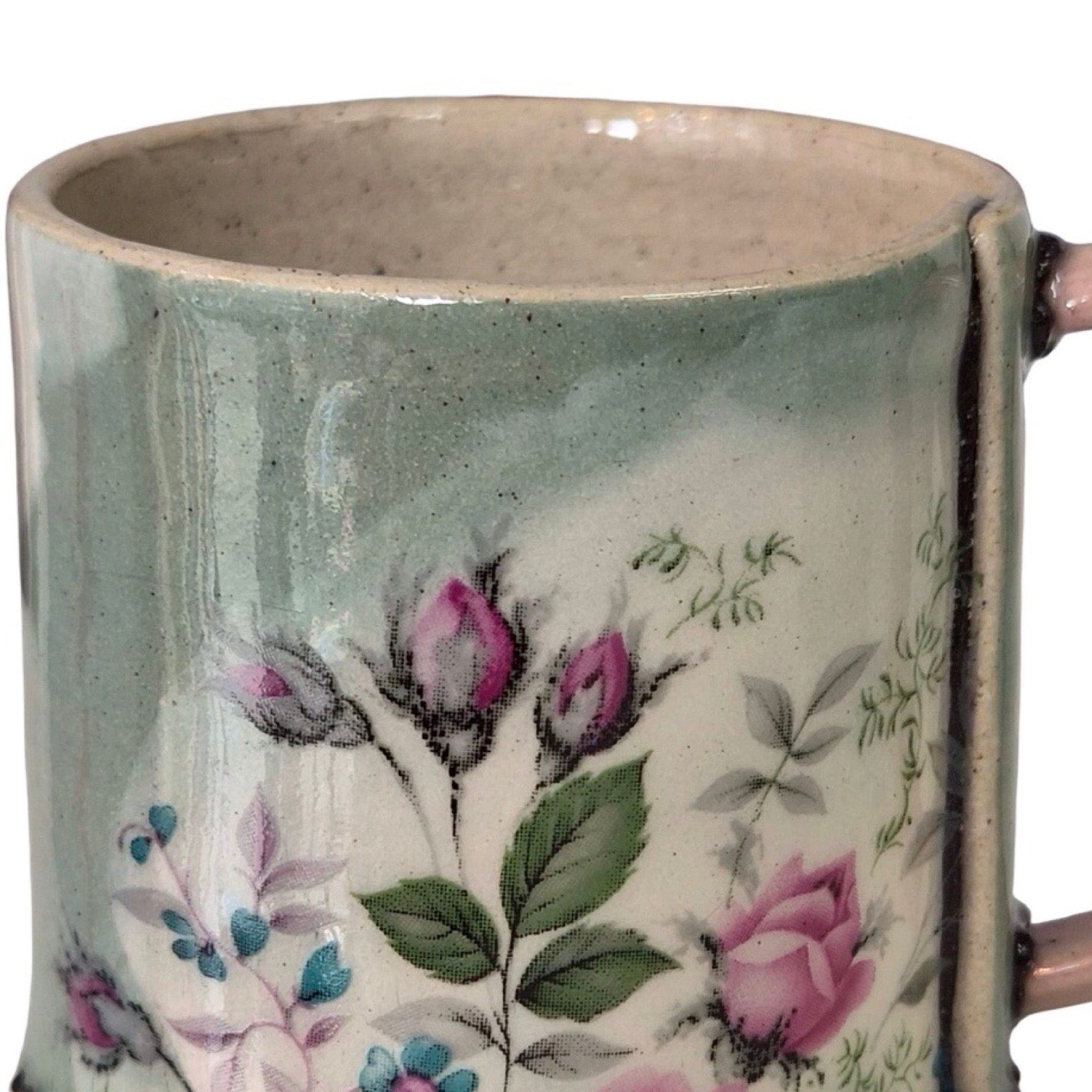 Ceramic mug with floral design on a white background.