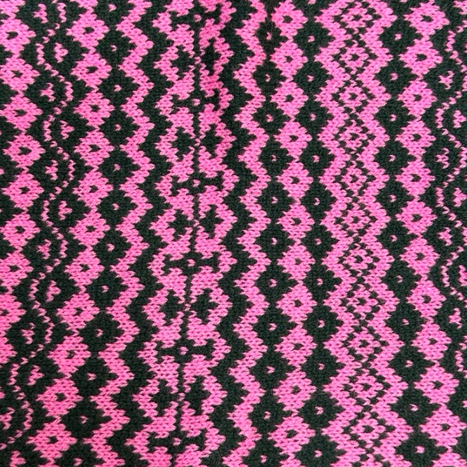 Super soft and cosy 100% lambswool knitted snood in a pink and black geometric stripes design.